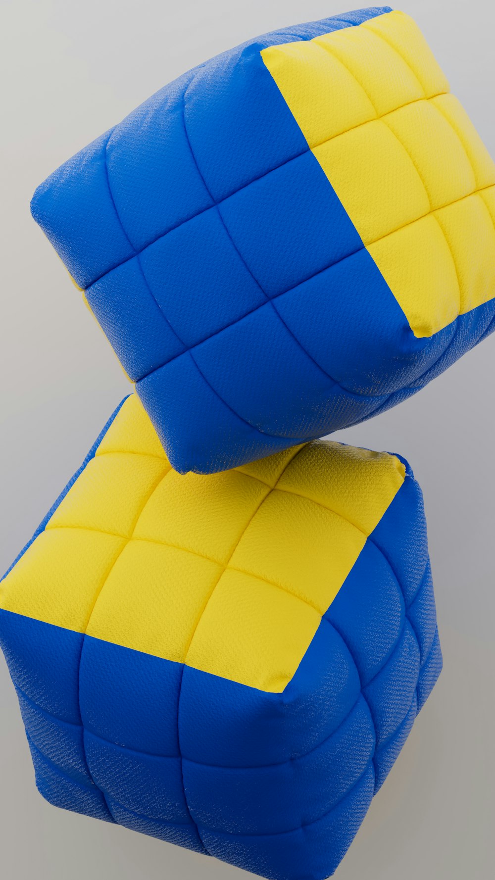 two blue and yellow cushions sitting on top of each other