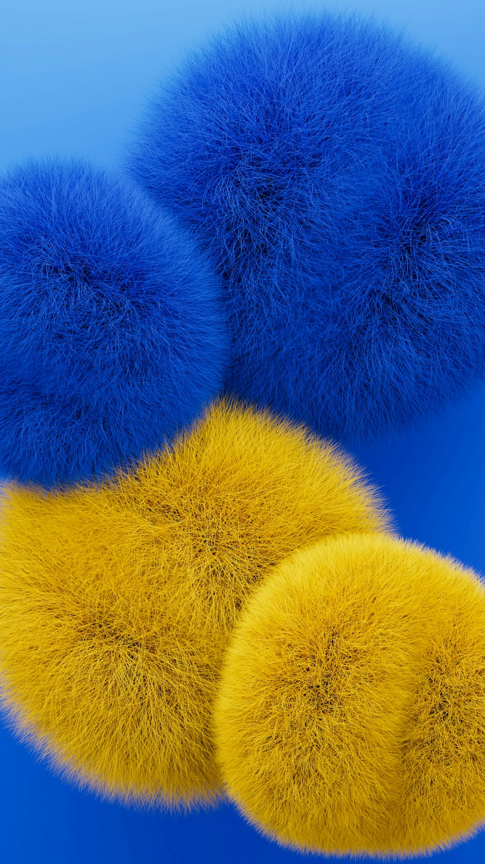three balls of blue and yellow fur on a blue background