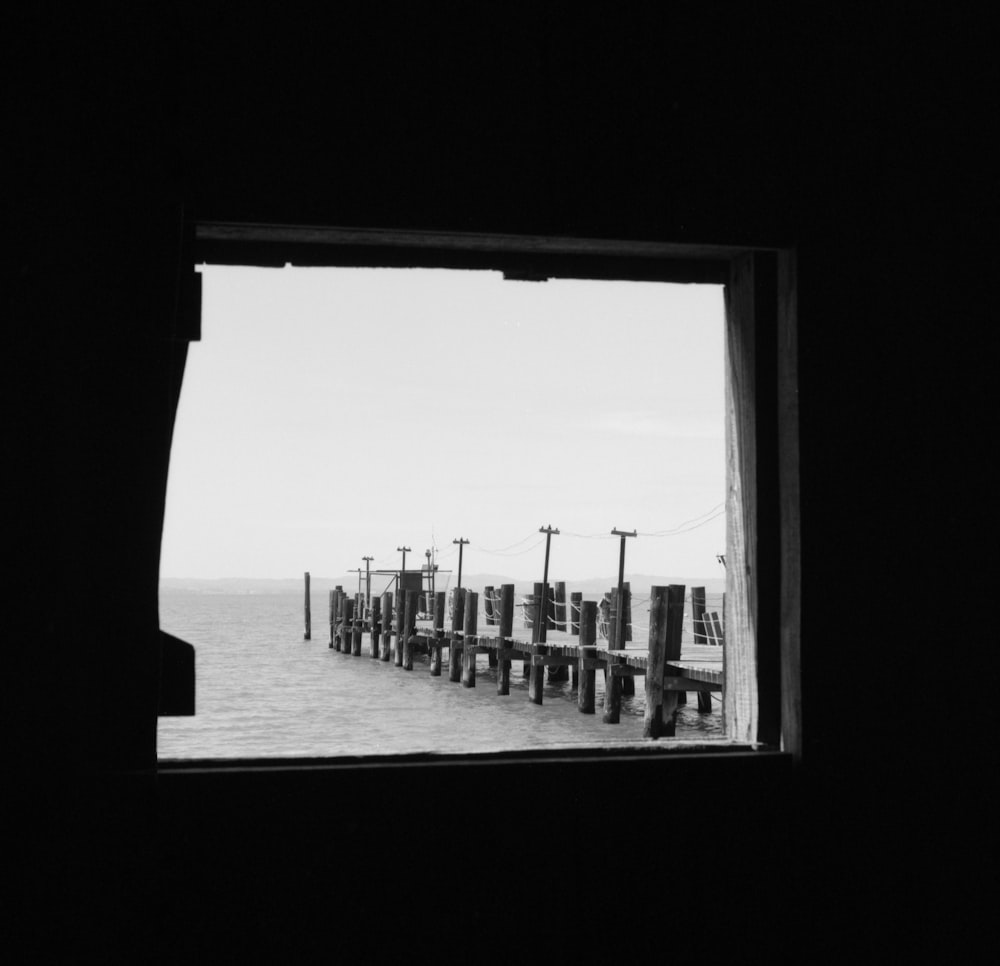 a black and white photo of a pier