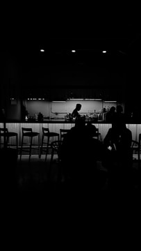 Juan Baraza in a minimalist film scene, bathed in soft shadows.