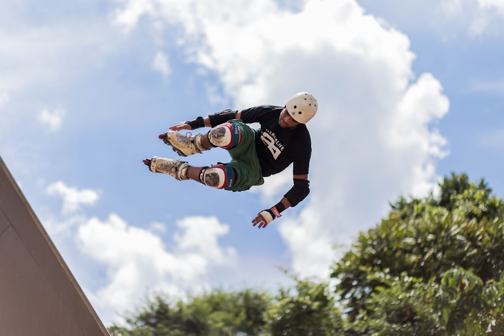 a man flying through the air while riding a skateboard