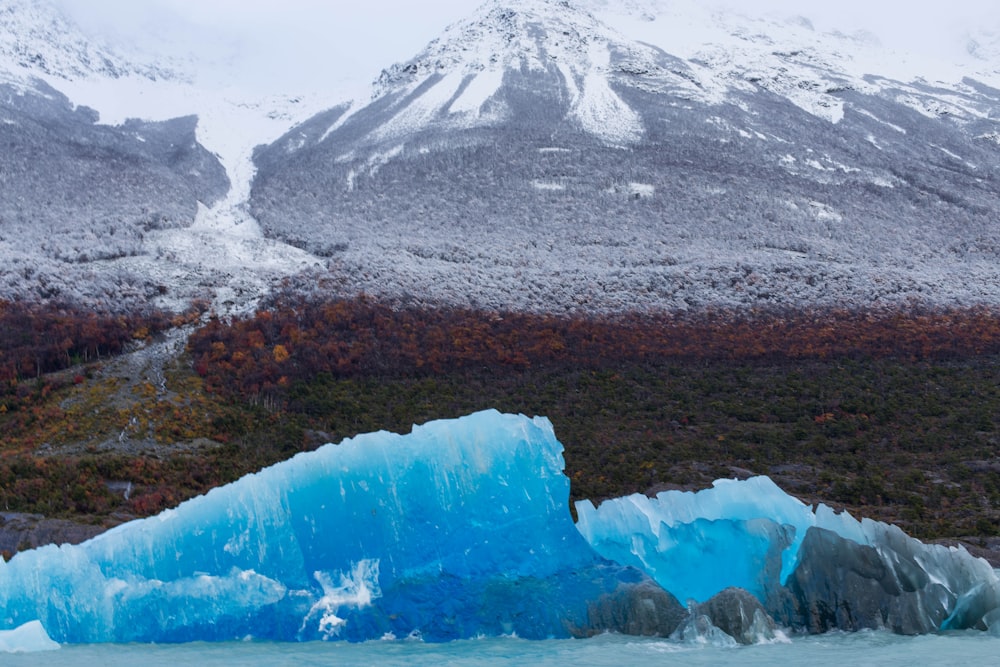 a large iceberg floating on top of a body of water