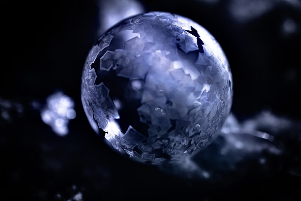 a close up of a glass ball on a black background