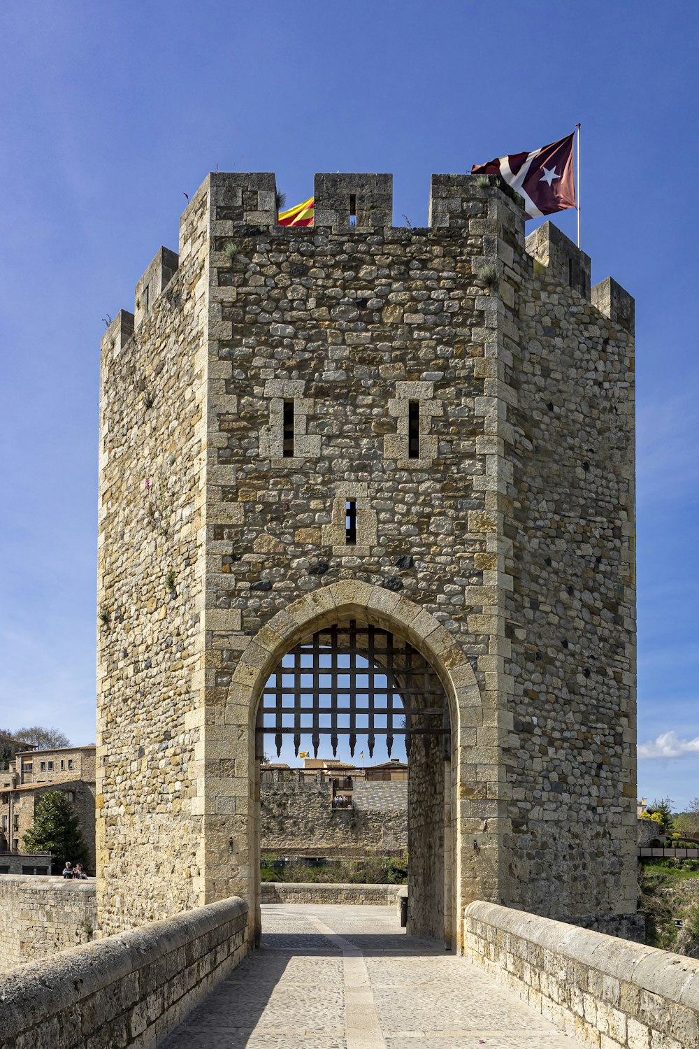 a castle gate with a flag on top of it