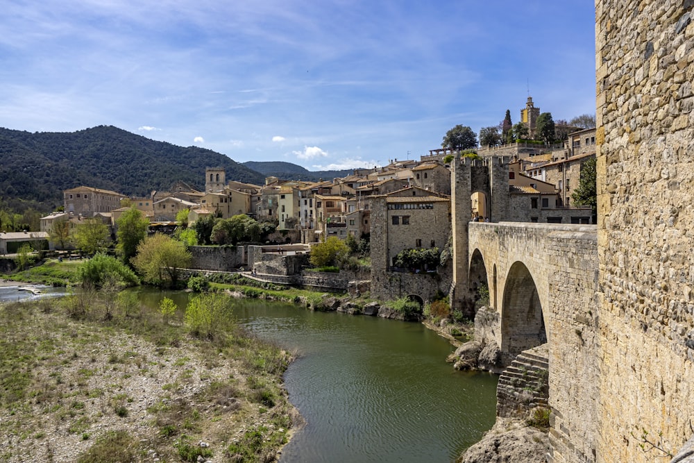 a river running through a small town next to a bridge