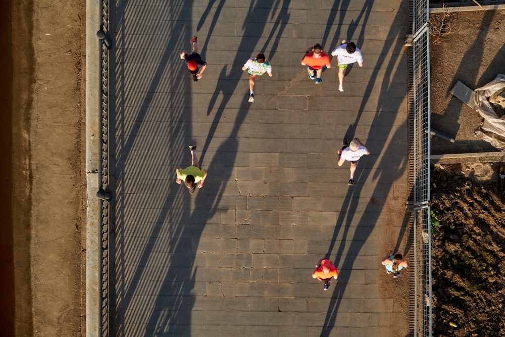 a group of people walking across a bridge