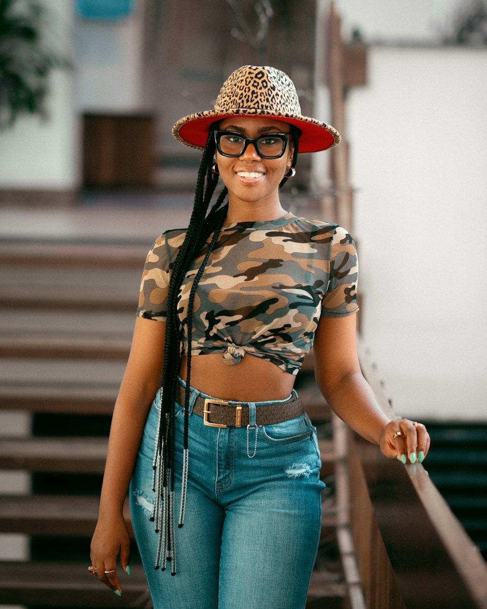 a woman wearing a leopard print hat and jeans