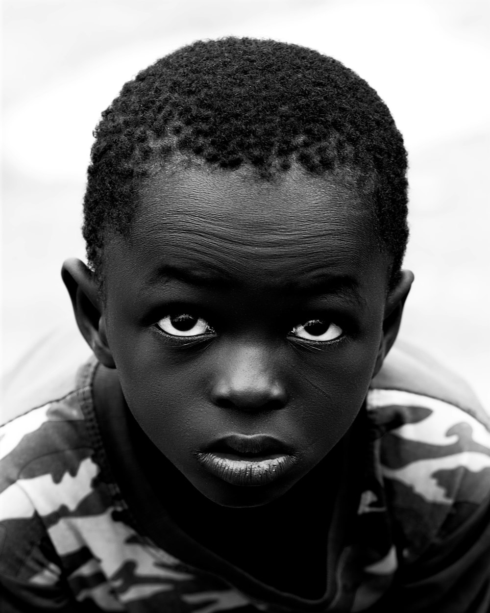 a young boy with a serious look on his face