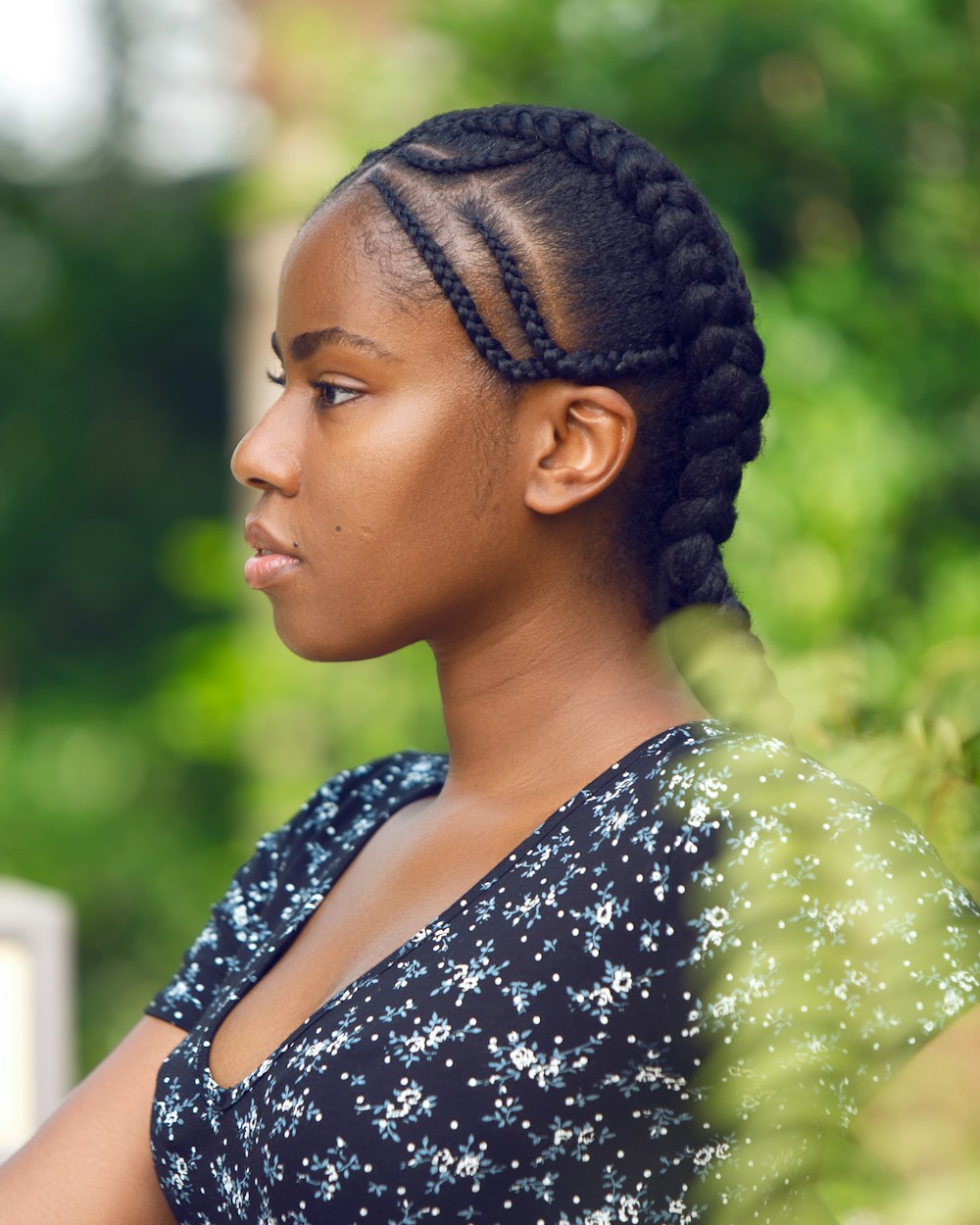a woman with braids is looking away from the camera