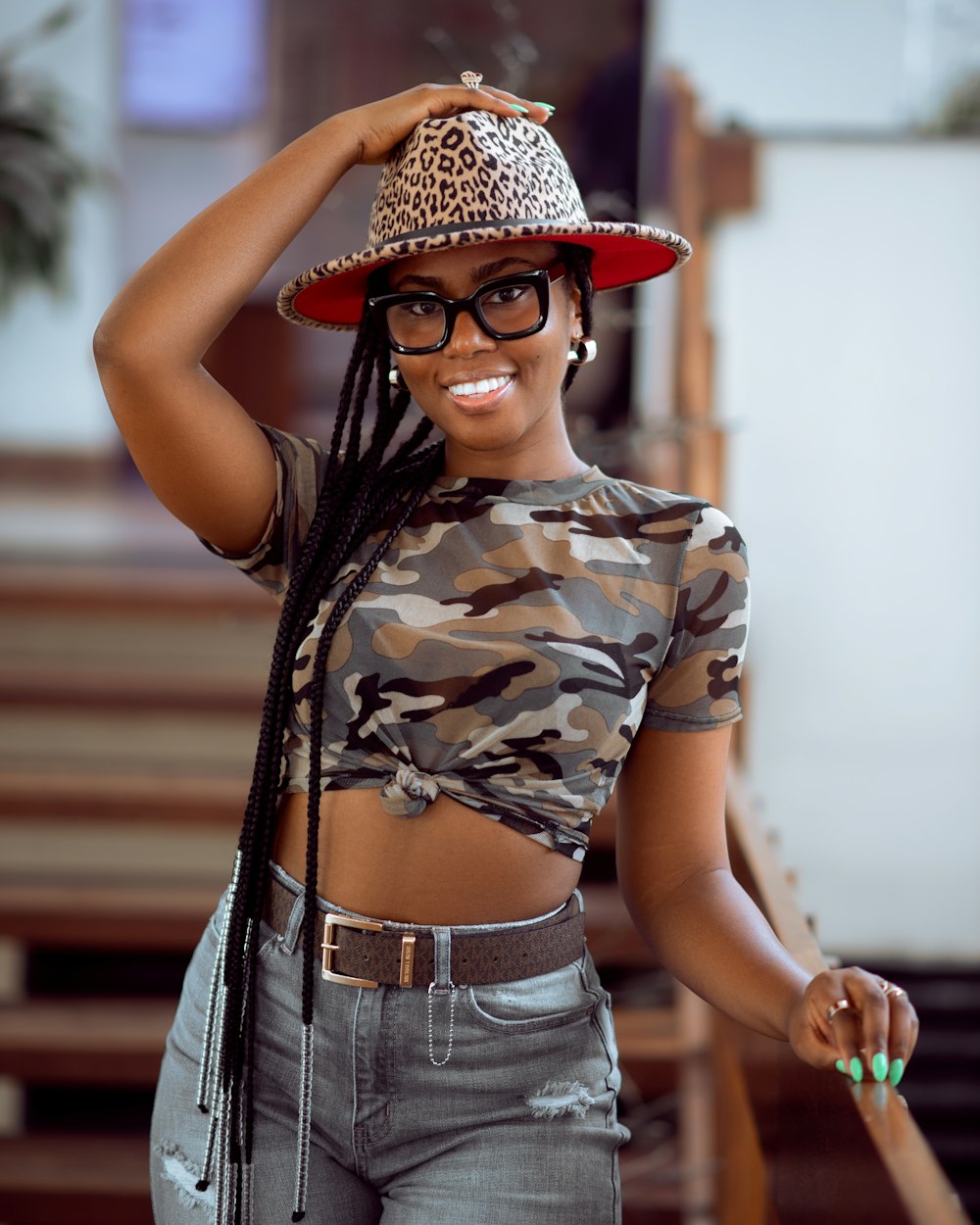 a woman wearing a leopard print hat and glasses