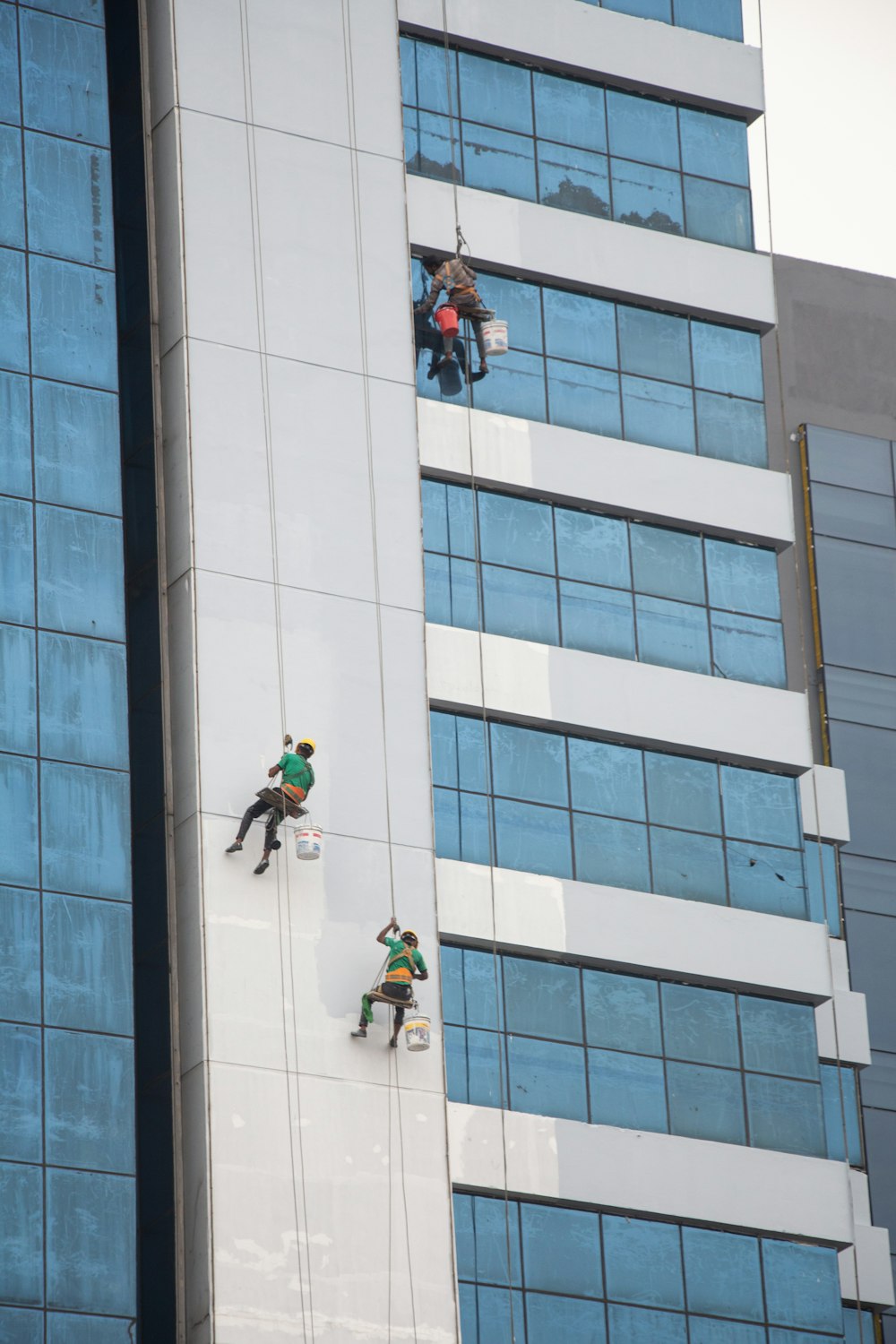 a group of people climbing up the side of a tall building