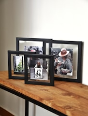 a couple of frames sitting on top of a wooden table