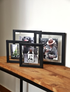a couple of frames sitting on top of a wooden table