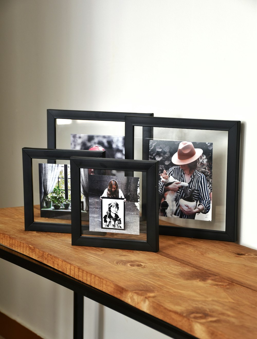 a couple of frames sitting on top of a wooden table