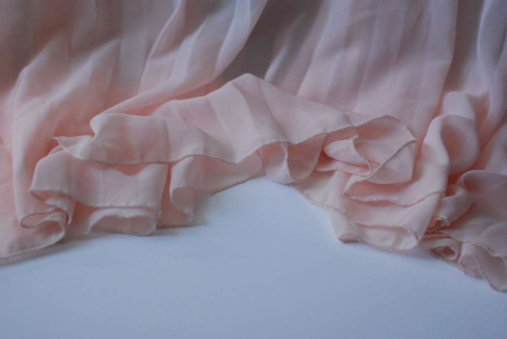 a close up of a pink curtain with ruffles