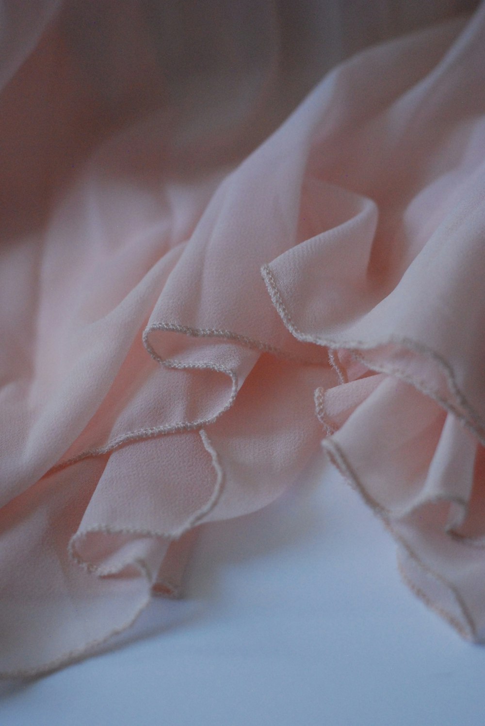 a close up of a pink fabric with ruffles