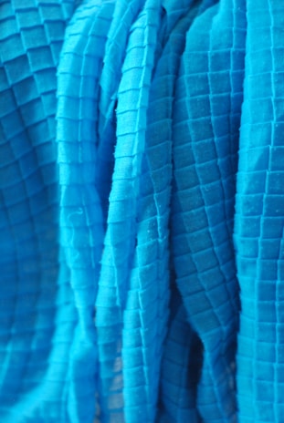 Overhead shot of fabric pieces arranged in a grid pattern, highlighting texture and form.