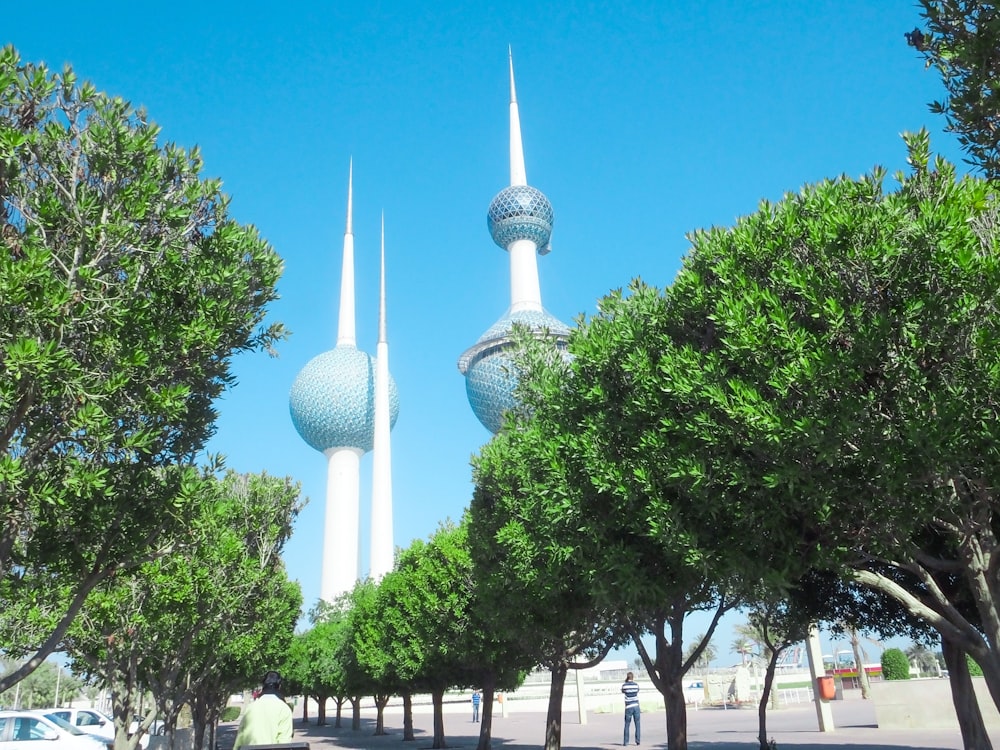 a couple of tall buildings sitting next to trees