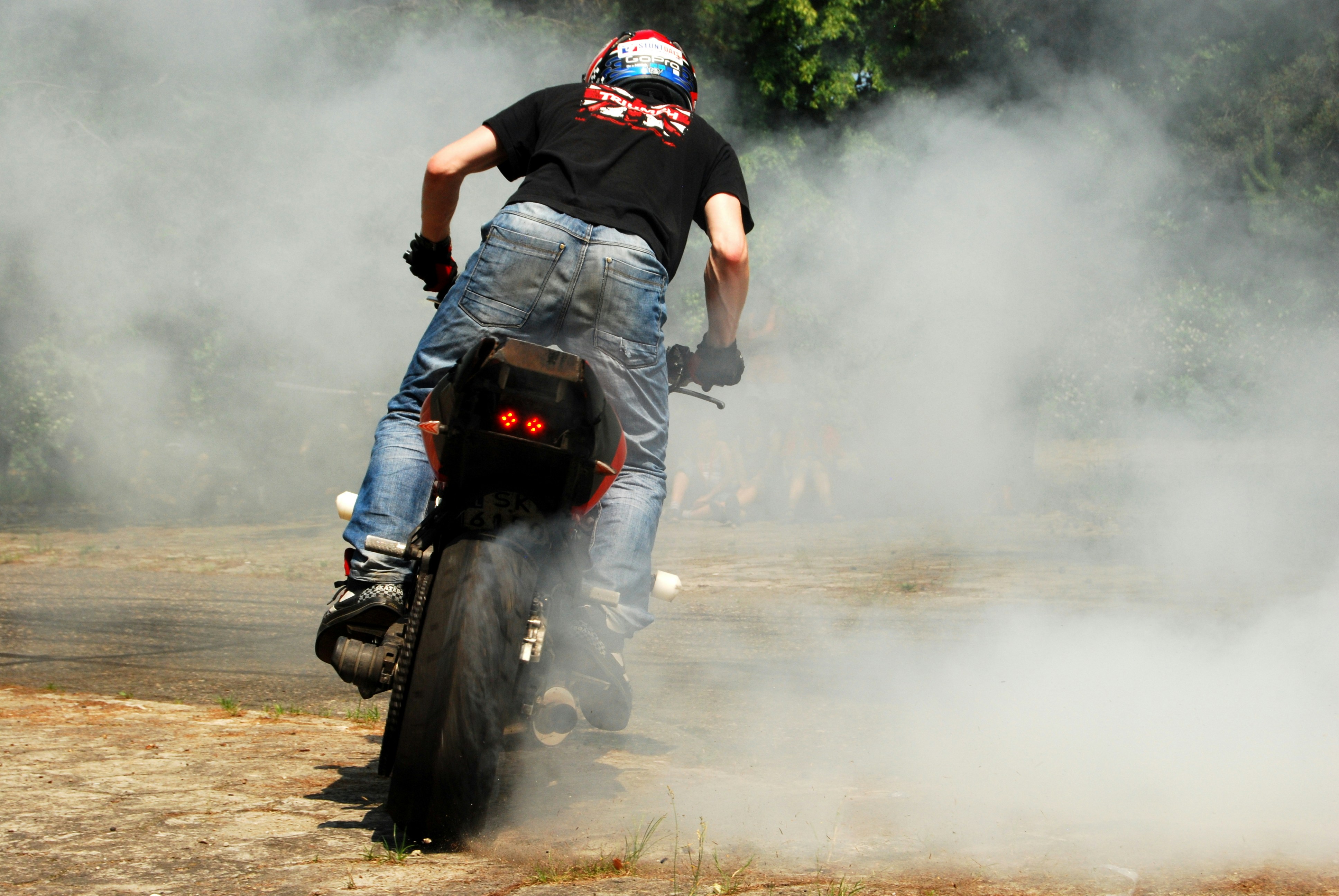 a man riding a motorcycle on a dirt road