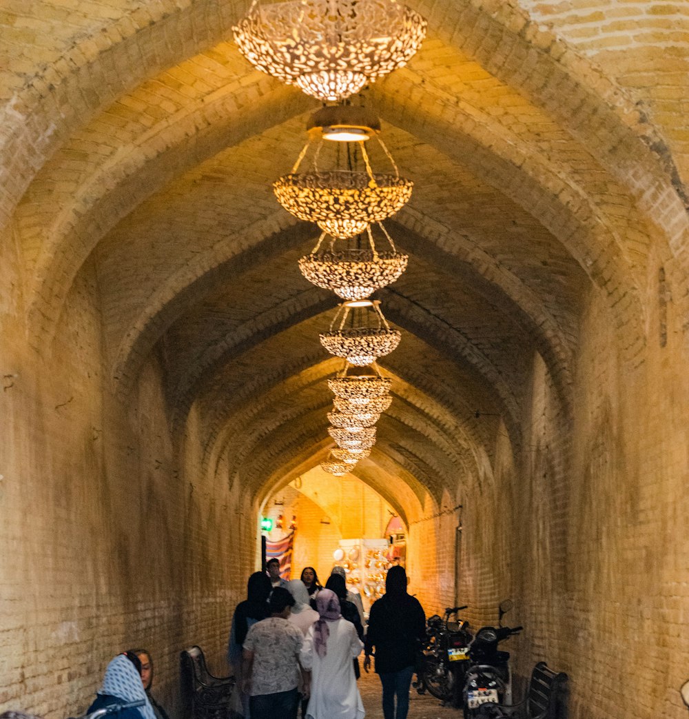 a group of people walking down a long hallway