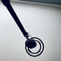 a black and white photo of a clock on a pole