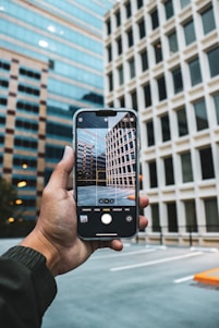 a person taking a picture of a building with their cell phone