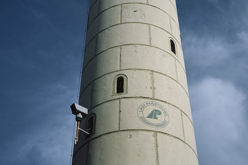 a white lighthouse with a blue sky in the background