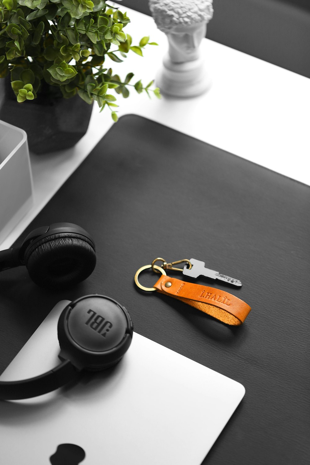 a pair of headphones sitting on top of a laptop