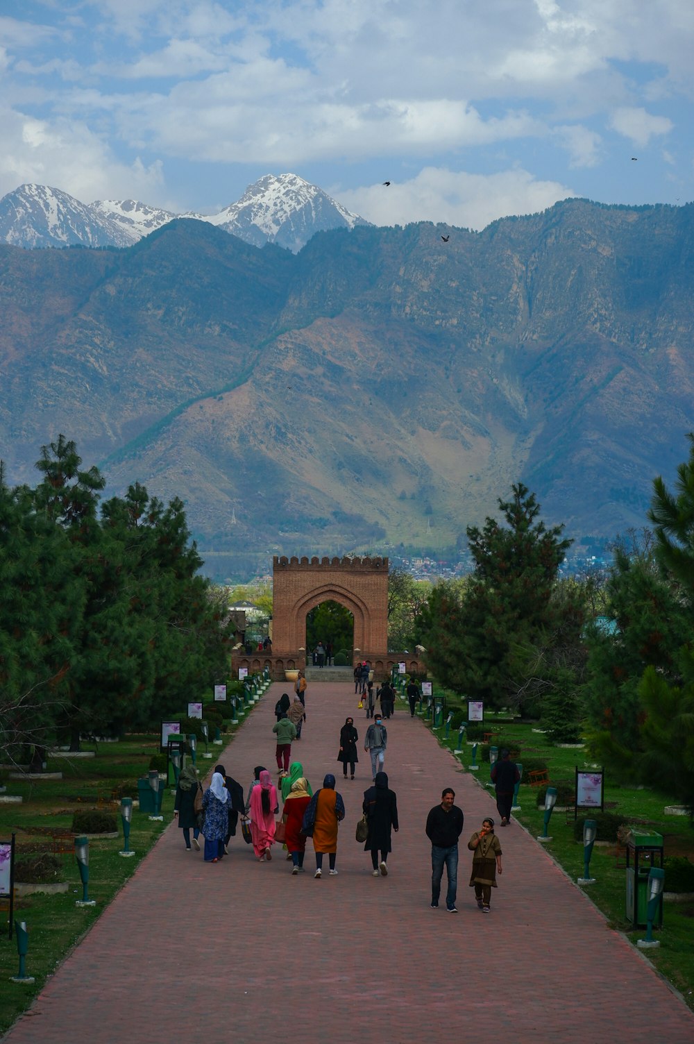 a group of people walking down a walkway