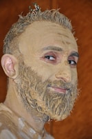 Male face scrub texture shown on a hand with natural sunlight highlighting its grainy richness.