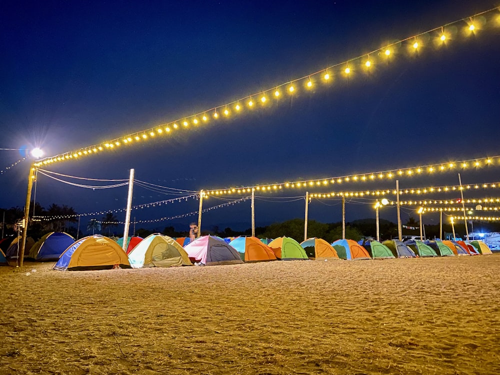 a bunch of tents are set up on the beach