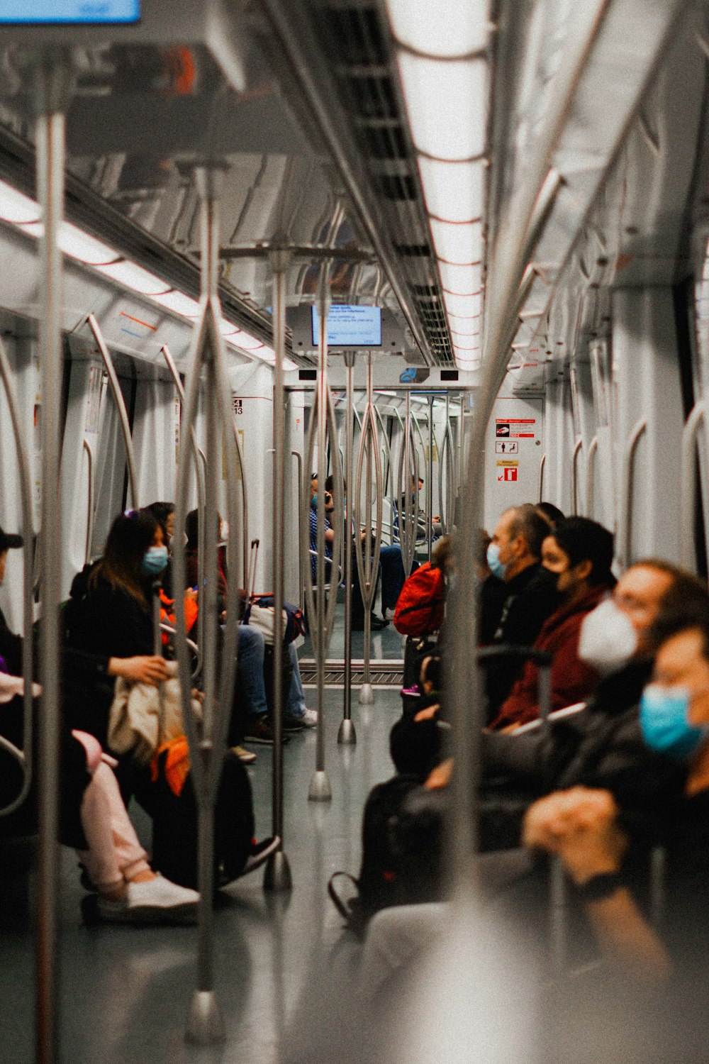 a group of people sitting on a subway train