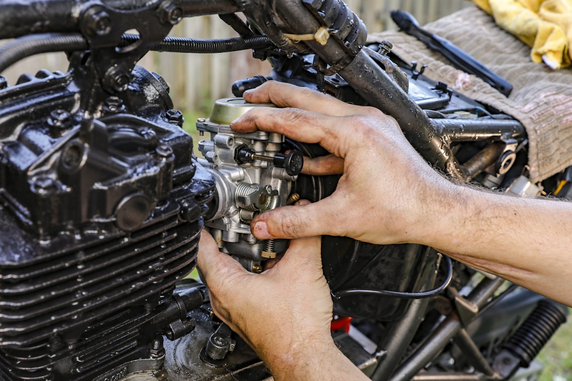 Mechanic inspecting a motorcycle engine