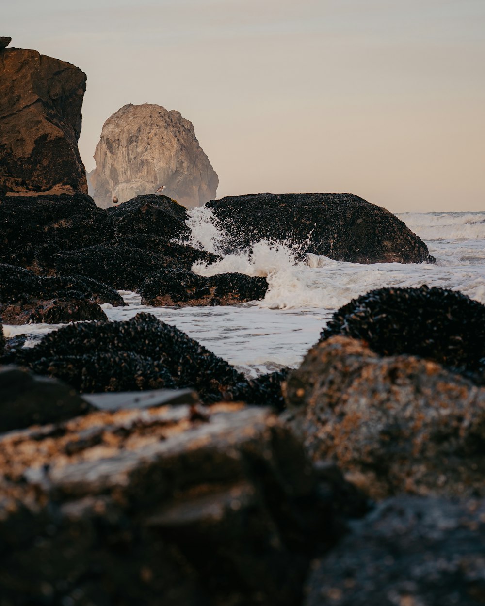 a rocky beach with waves crashing against it
