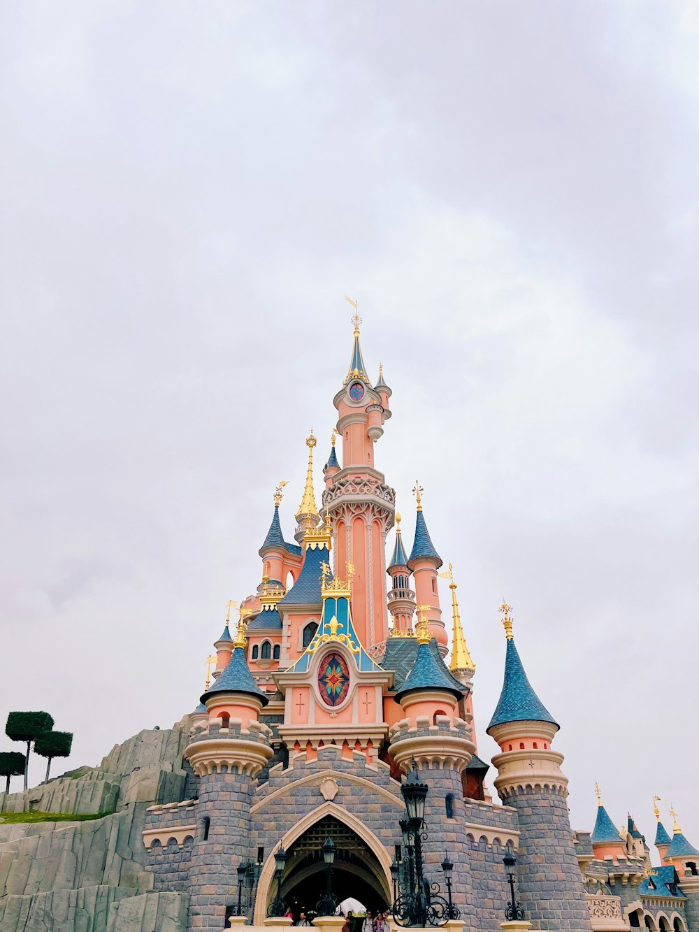 a castle with blue and pink rooftops