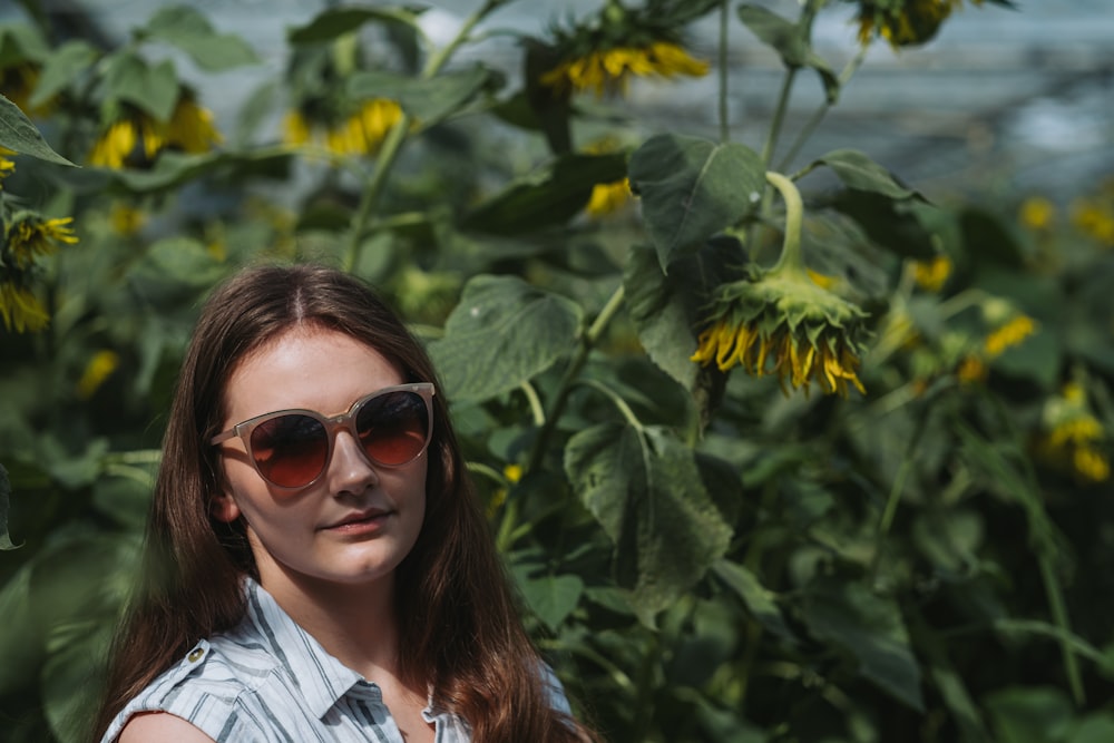 a woman wearing sunglasses posing for the camera