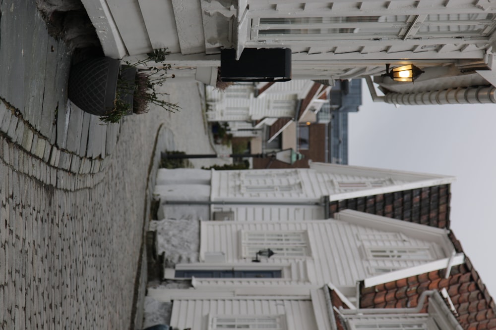 a cobblestone street with white buildings on either side of it