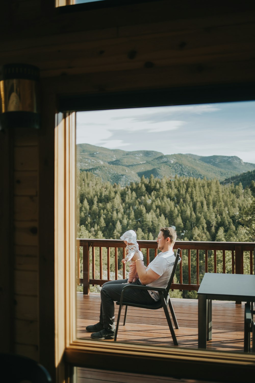 a person sitting on a bench in front of a window