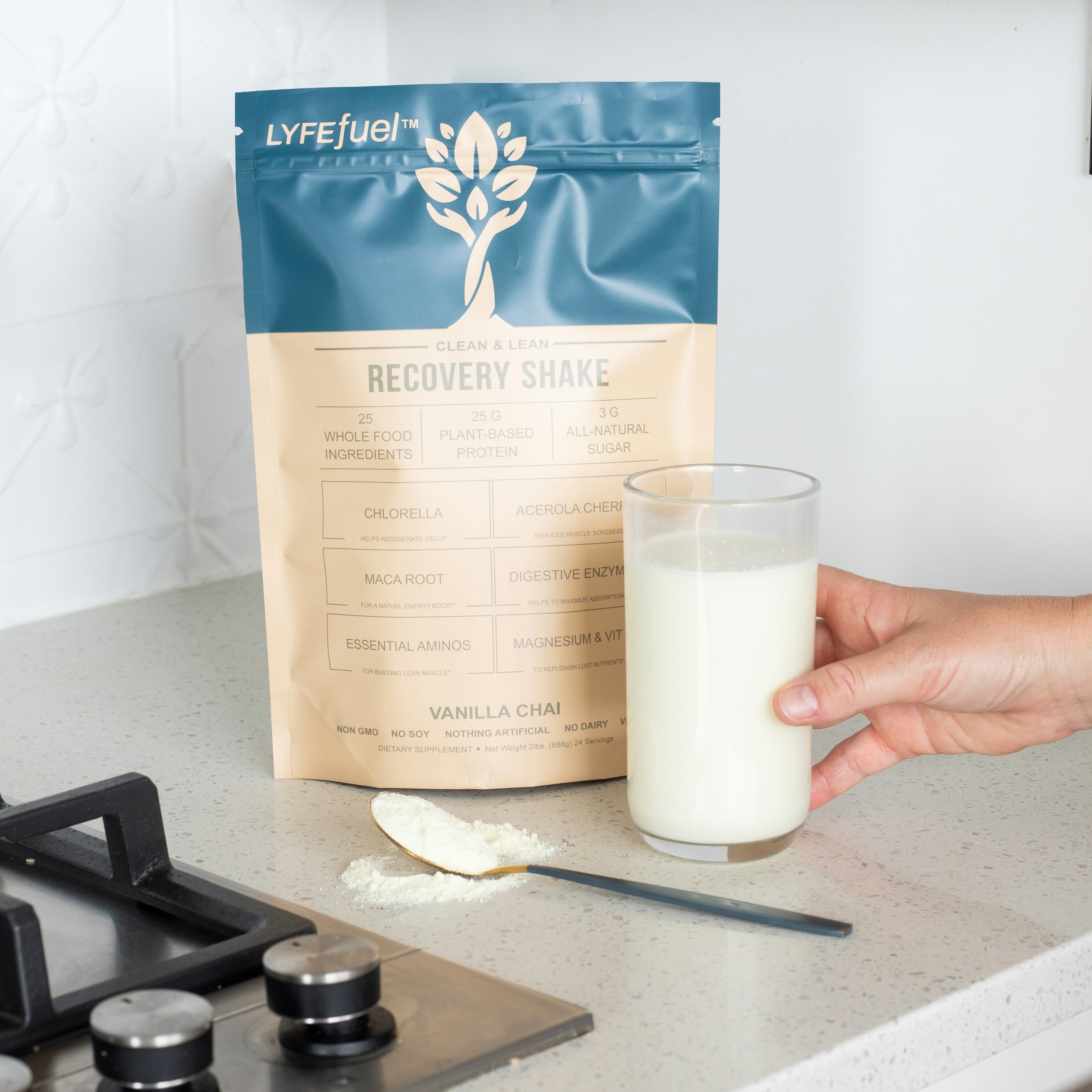 a hand holding a glass of milk