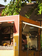 Close-up of a colorful, customized menu board displayed on a food truck.