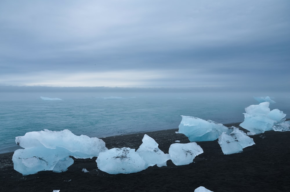 a group of icebergs on a beach