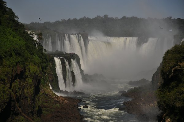 A waterfall with a bridge and trees — Foz do Iguaçu, Brazil