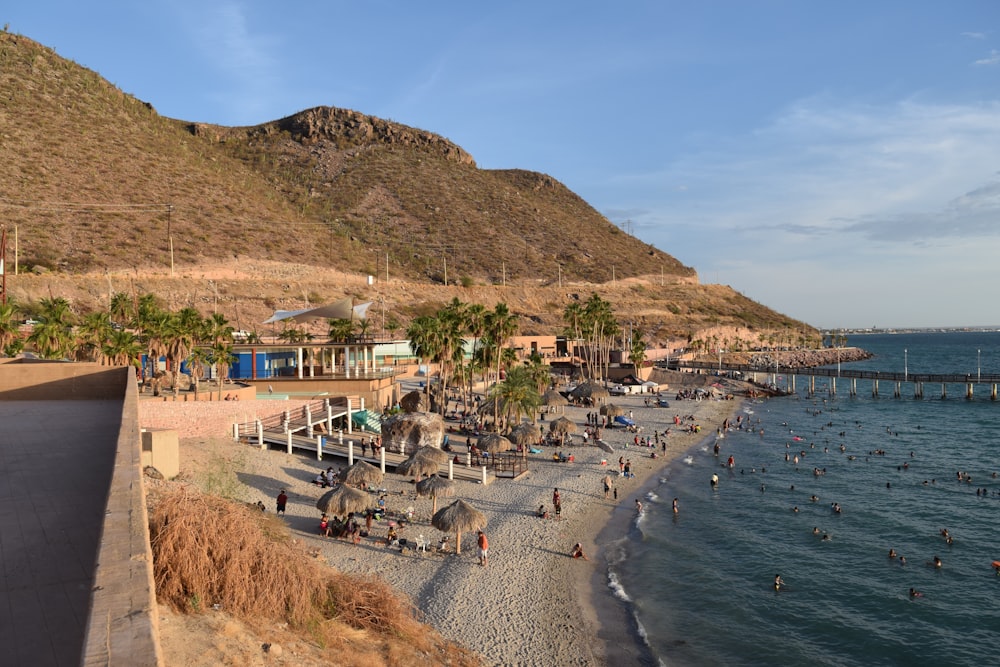 a beach with people and buildings