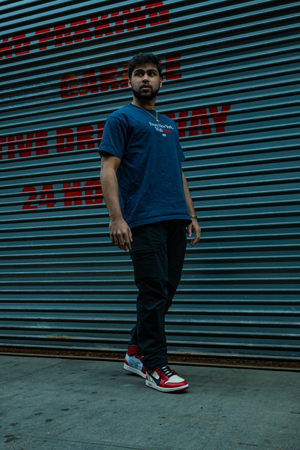 a man standing in front of a blue wall