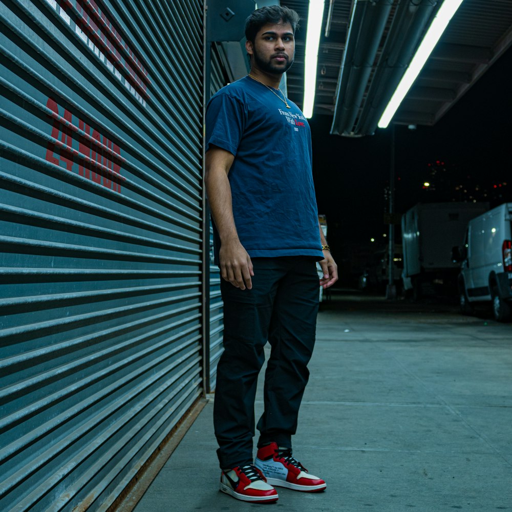 a man standing in front of a garage door