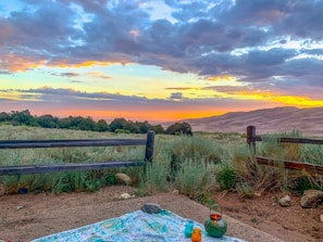 Sunset background with maxssala cans placed on a picnic table, evoking relaxation.