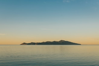 a body of water with land in the distance