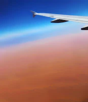 A scenic view of an Indian landmark visible from an airplane window during descent.