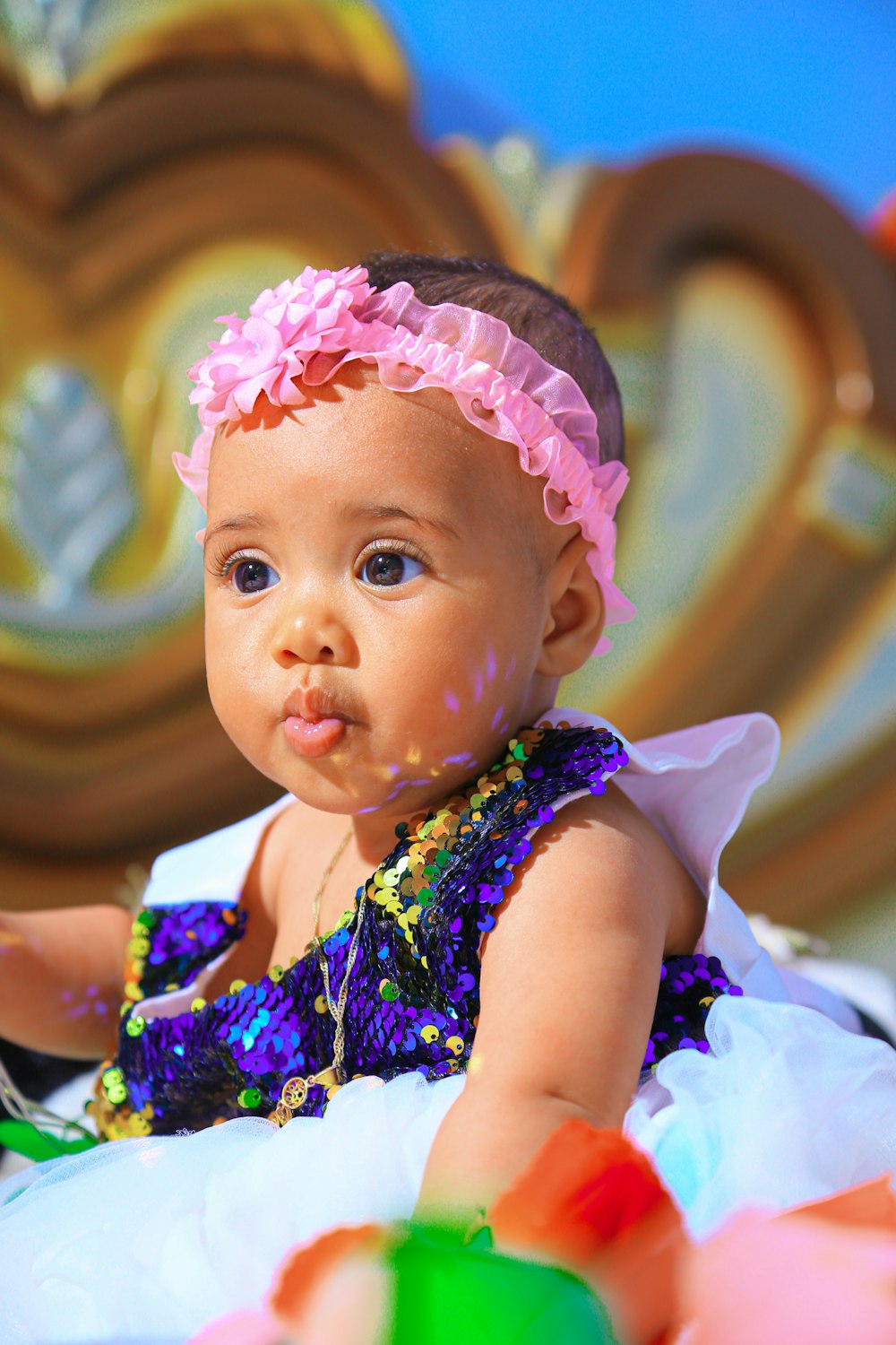 a baby with a pink headband