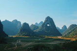 a landscape with mountains in the back with Li River in the background
